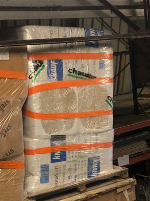 boxes of toilet paper are stacked on top of each other in a warehouse