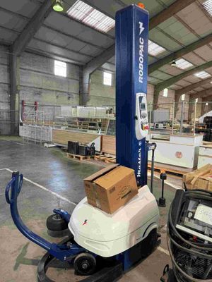 an image of a forklift in a warehouse with boxes on it