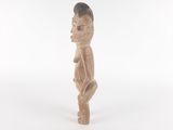 an image of a wooden statue of a man with a hat on