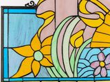 a picture of a stained glass window with flowers on it