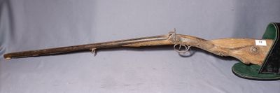 an old rifle with a wooden handle and a green case