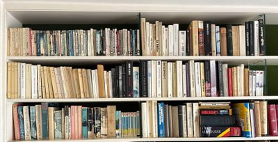 a book shelf with many books on it in a room