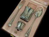 a box with silverware in it on a black background