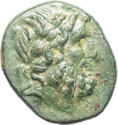 a close up of a coin with a face on it