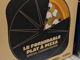a box of pizza sitting on a shelf in a store