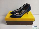 a pair of blue shoes sitting on top of a yellow box