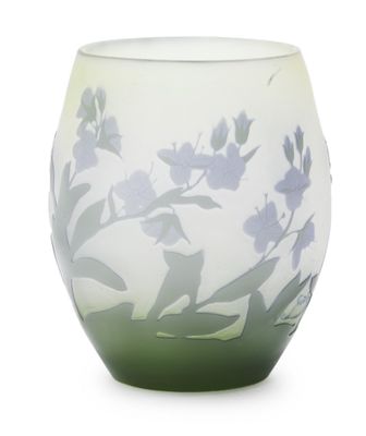 a glass vase with a green and white design on it