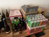 many bottles and cans of wine on a table