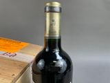 a bottle of wine sitting on a table next to a box