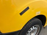 a yellow truck parked on the side of the street