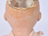a doll that has a broken head on it ' s head