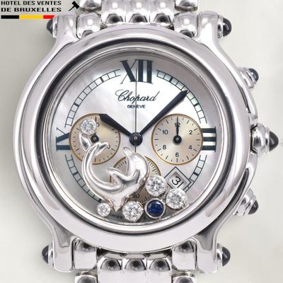 a close up of a watch on a white surface