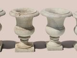 four vases sitting next to each other on a table