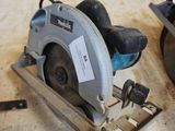 someone is using a circular saw to cut a piece of wood