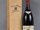 a bottle of wine in a wooden box next to a bottle of wine