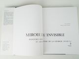 a book open on a white table with a black and white title