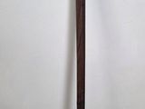 a wooden pole that is standing up against a white wall