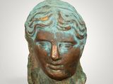 a bronze head of a woman with her eyes closed