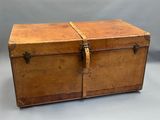 an old wooden trunk sitting on top of a white table
