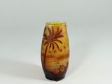 a small vase with a palm tree on it