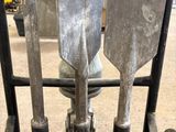 three shovels that are sitting on a cart