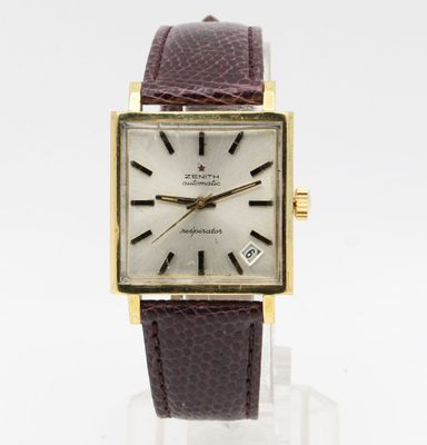 a close up of a wrist watch with a brown leather strap