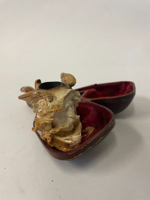 a small box with a statue inside of it on a table