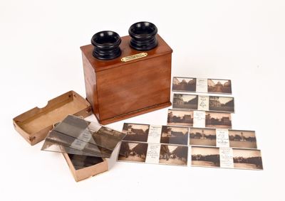 a wooden box with pictures and a pair of binoculars on it