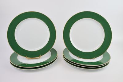 three green and white plates are stacked on top of each other