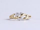an image of a gold and diamond ring on a white background