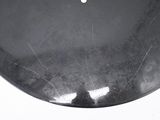 a black plate with a white dot on it