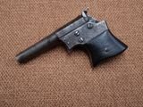 a close up of an old gun on a brown carpet