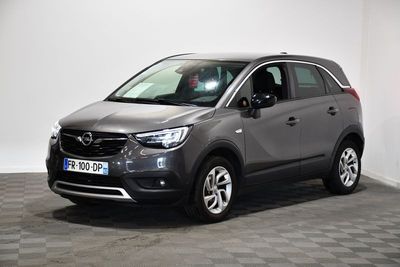the grey opel is parked in a room with a checkered floor