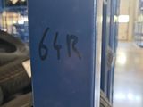 the back end of a car with a number on it in a garage