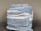 a stack of blue jeans wrapped in white string