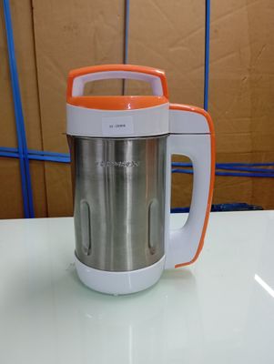 an orange and white blender sitting on a table