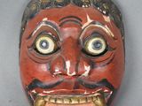 une image représentant un masque rouge arborant un large sourire