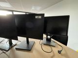 two monitors sitting on a desk with wires attached to them