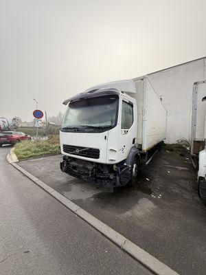 two trucks that are parked next to each other on the side of the road
