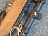 the rifle is laying on the floor next to the rifle scope