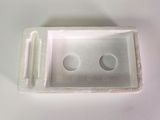 a white box with two holes in it on a table
