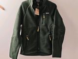 the north face flee jacket is hanging on a hanger