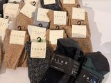 several pairs of men ' s socks with tags on them on a table