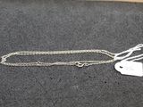 a silver necklace with a heart charm on it
