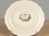 a white plate with a design on it sitting on a table