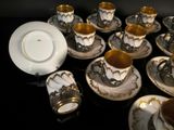 a lot of cups and saucers on the table