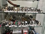a glass display case with many watches on it