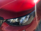 a close up of a red car ' s headlight