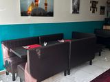 a room with a table, couches, and a chandelier in it