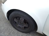 a white car with a flat tire on the street